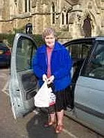 A Stroke Club member standing in front of a car