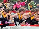 A close-up of rowers battling it out in a Dragon Boat final race