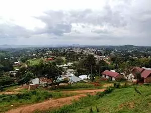 Mubende district sitting amongst green fiels and trees, with hills in the background