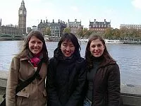 Three Ambassadorial Scholars standing beside the River Thames in London, with Big Ben in the background