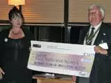 President of the Rotary Club of Abingdon Vesper, Richard Benton, presents a cheque for £2000 to Sharon Hylton of OXPIP