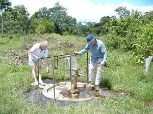 Two members of Abingdon Vesper Rotary club inspect the village well in Mubende