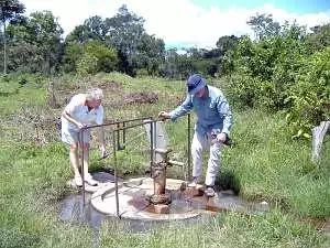 Two Rotary members test the funtioning of the water well at Kyamukoona