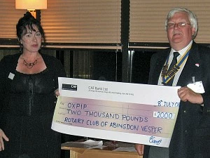 President of the Rotary Club of Abingdon Vesper, Richard Benton, presents a cheque for £2000 to Sharon Hylton of OXPIP