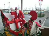 Santa sitting in his Abingdon Vesper sleigh outside Tesco